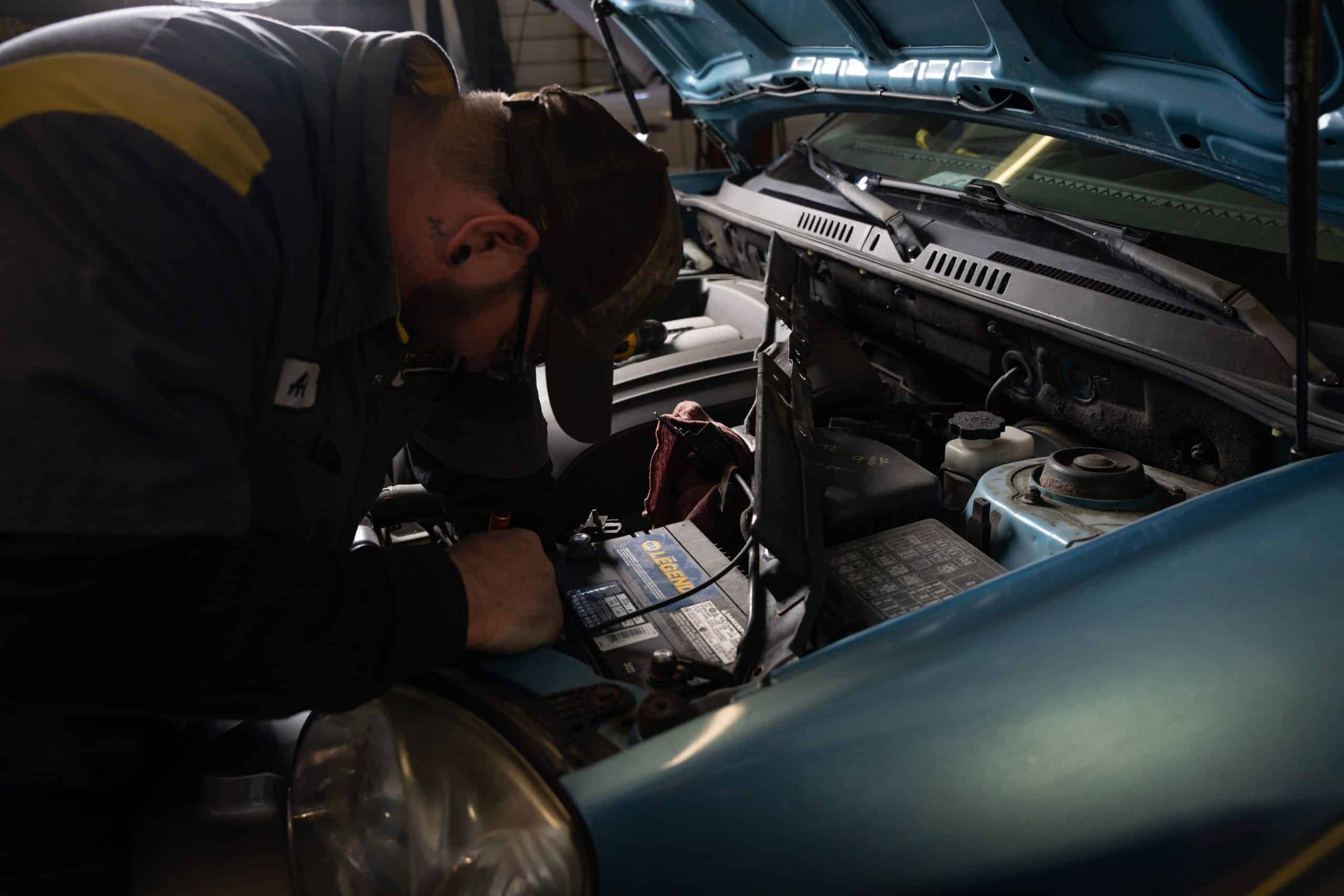 NAPA mechanic fixing car battery problems.